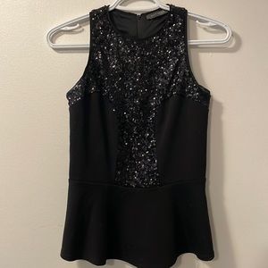Black shimmery shirt that flairs out at the hip!